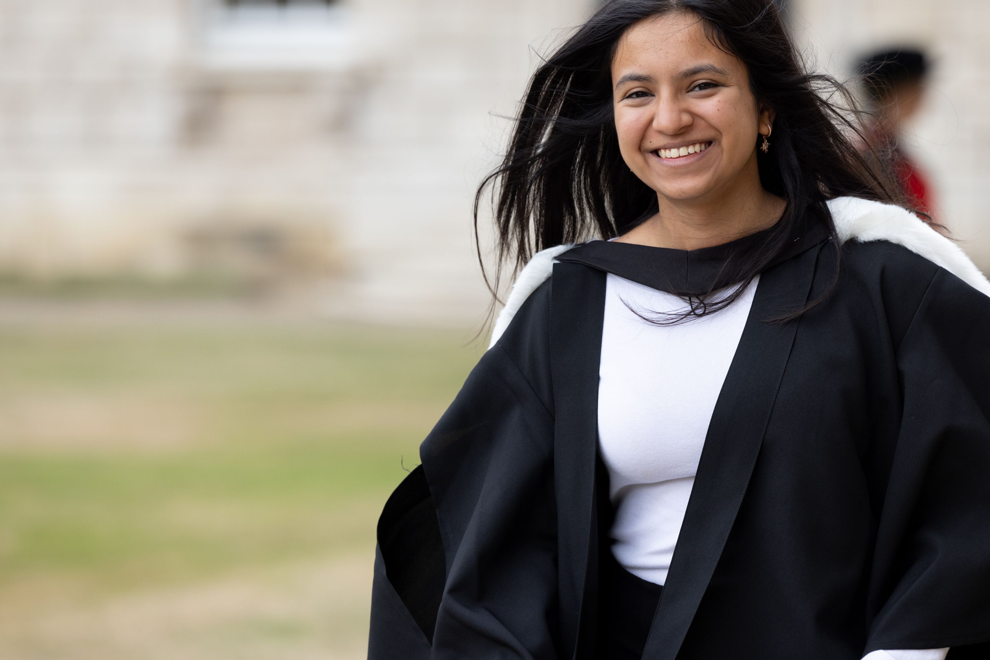 A female student in graduation robes