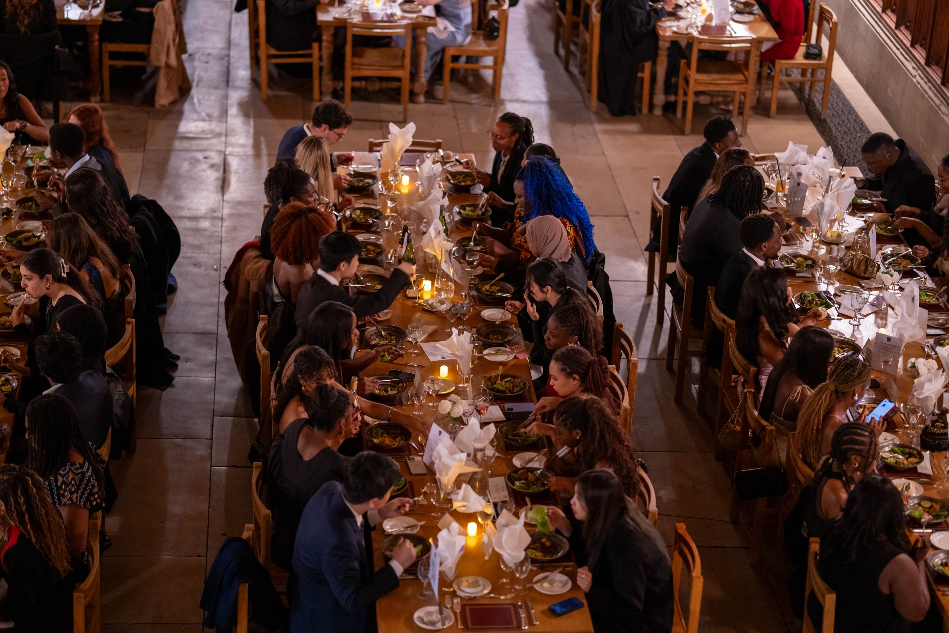 students in a formal dining hall meal